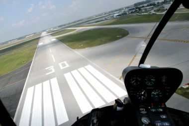 Helicopter approaching runway at airport